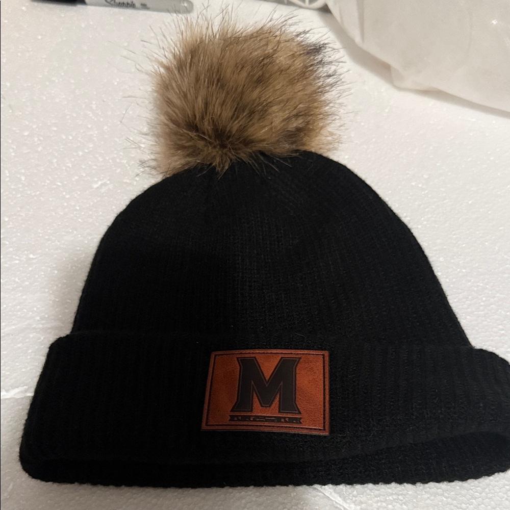 Black Knit Beanie with Faux Fur Pom U of Maryland logo in leather